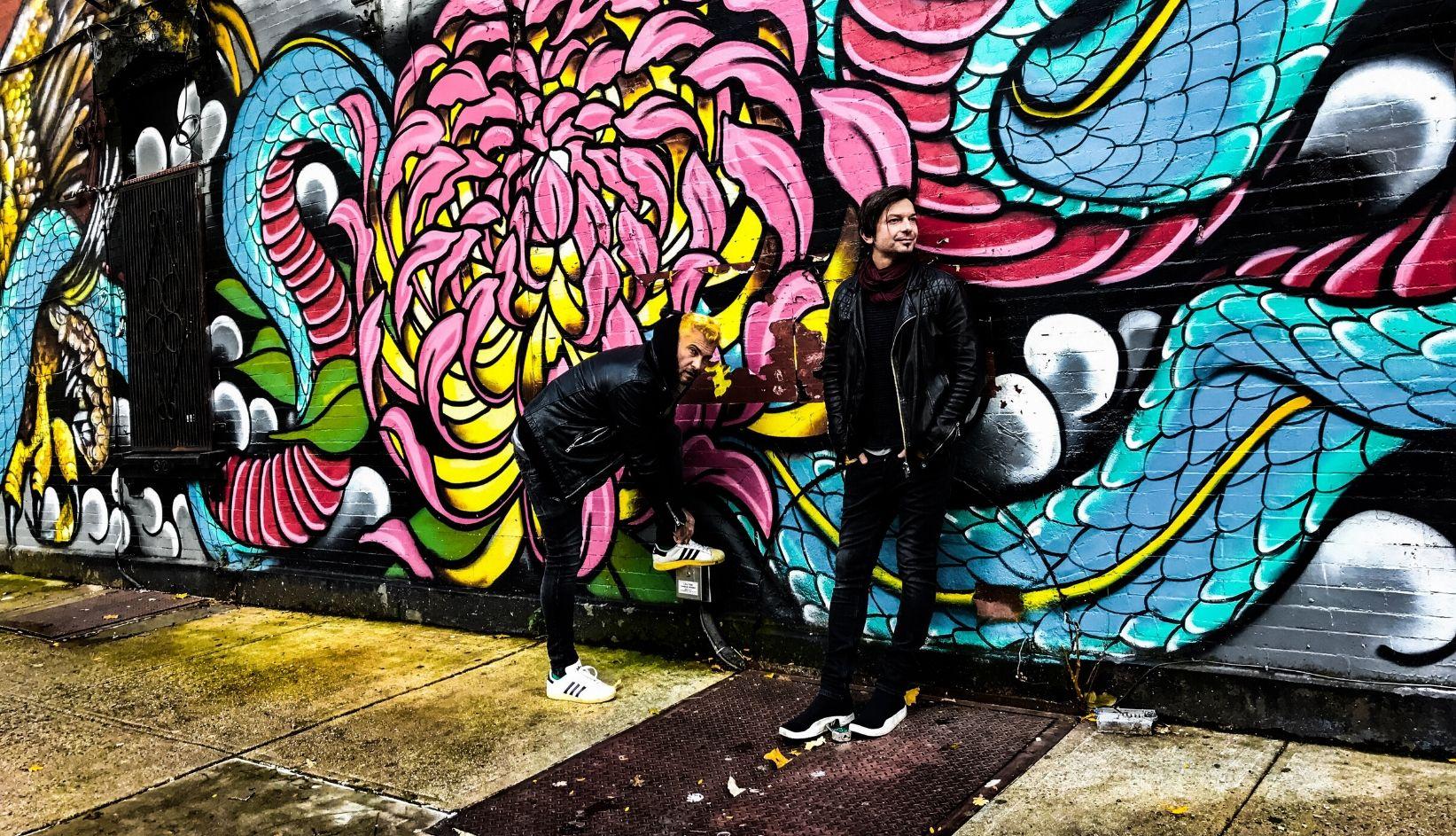 Two men by mural
