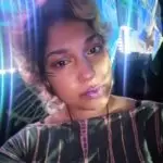 A woman with a projection of blurred lights around her