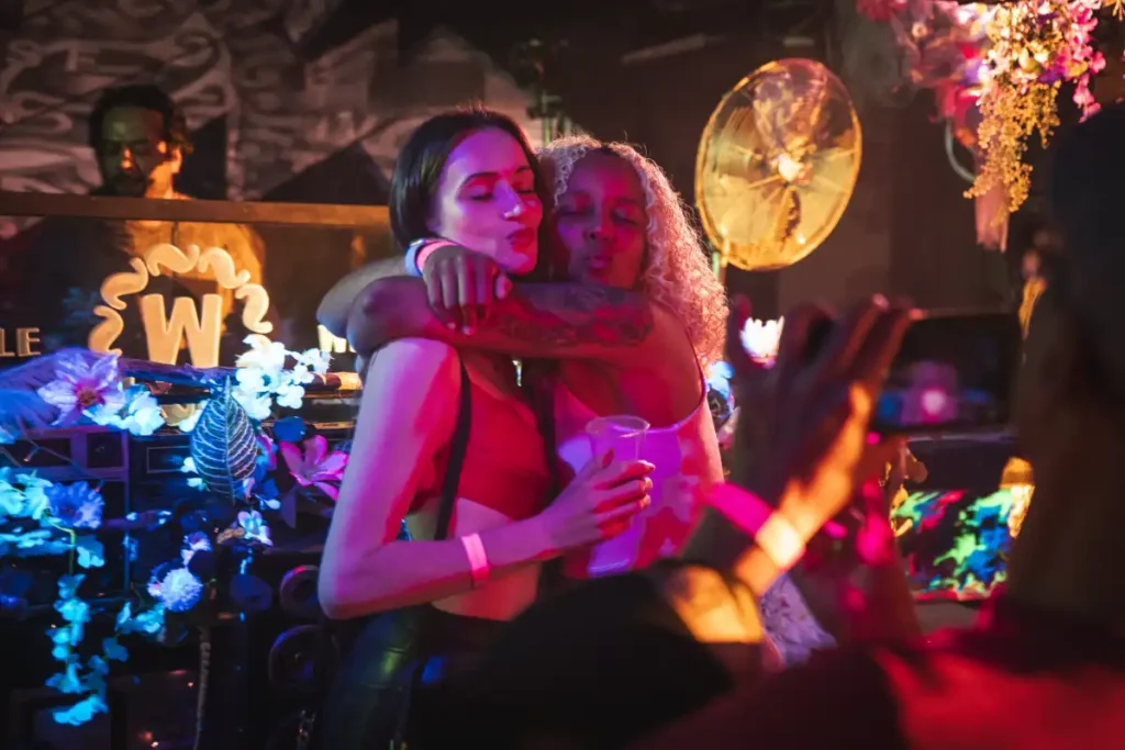 Two friends hug on the dance floor