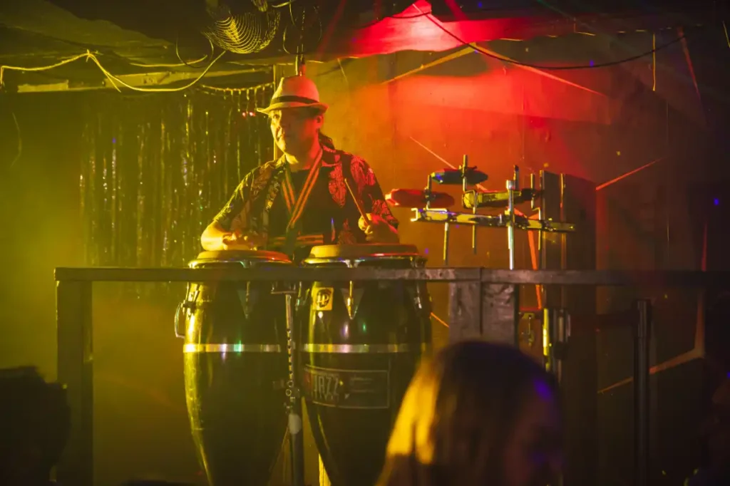 Bongo drummer above dancefloor