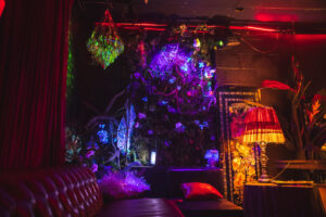 Couch, neon light, and art