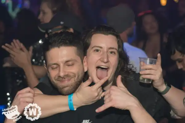 Two friends with tongue out