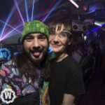 Two friends with laser behind