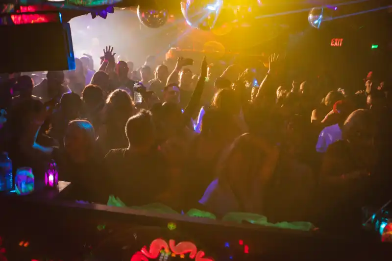 People dancing to in packed room