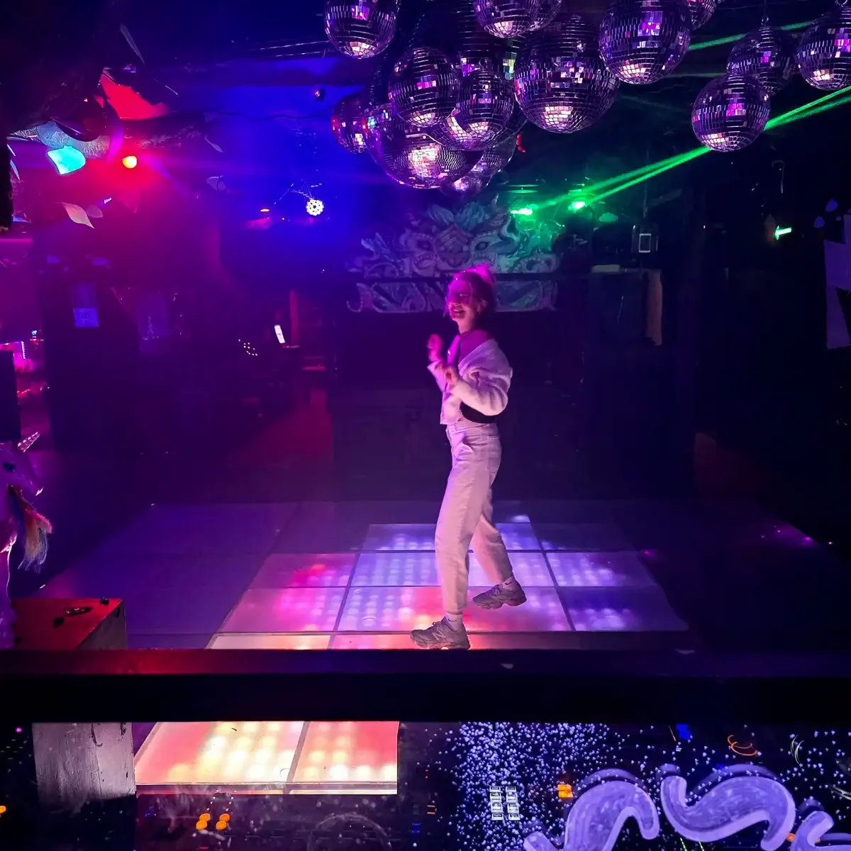 A woman on a disco dance floor