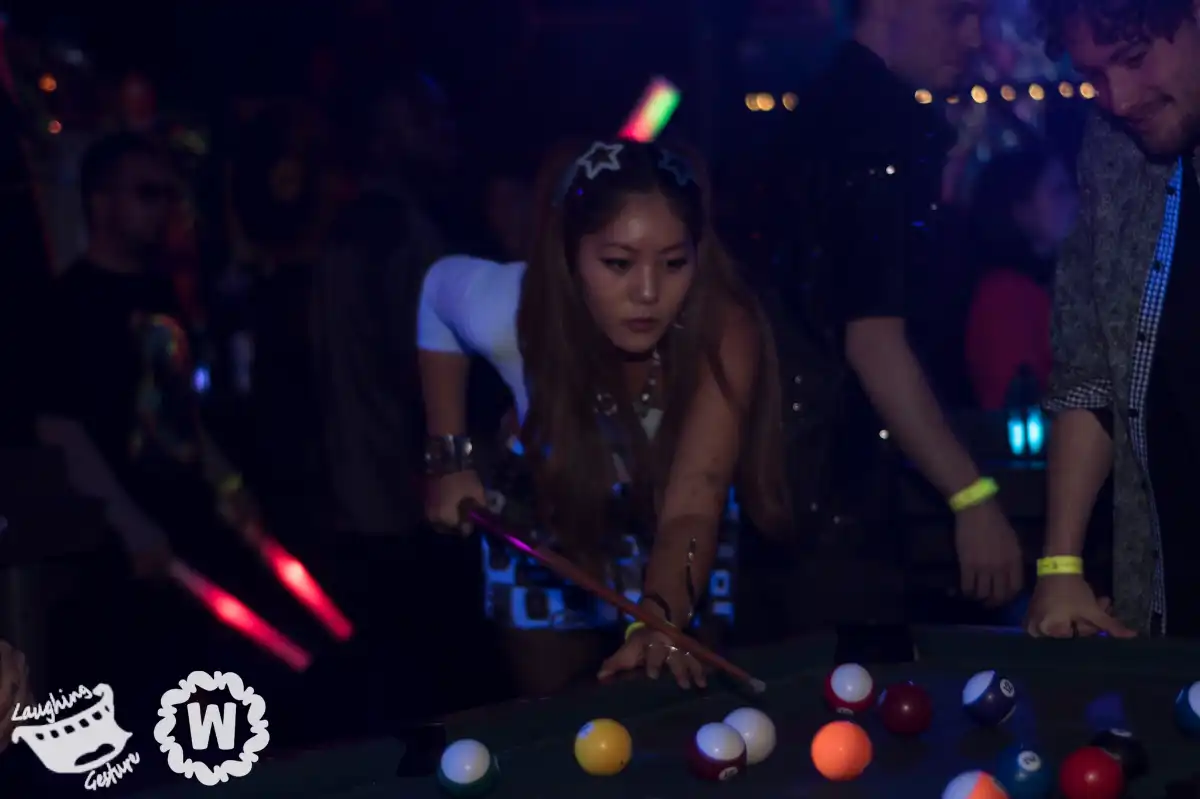 A woman playing pool