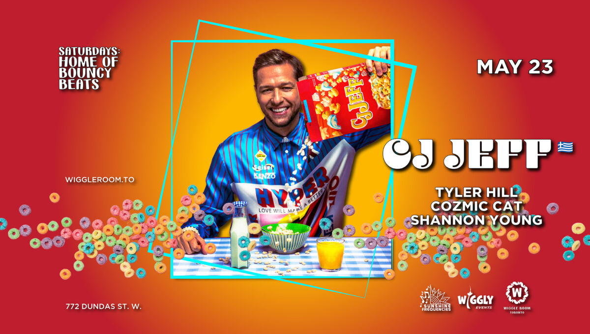 A smiling man in a colorful jacket holds up a box of E3 cereal at a table with milk, fruit, and cereal. Celebrate with CJ Jeff, Tyler Hill, Cozmic Cat & Shannon Young—May 23 at 772 Dundas St. W., home to epic Toronto raves!.