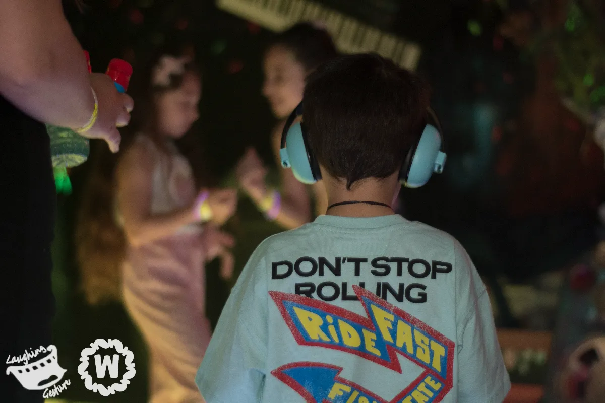 Boy with headphone silencers on and fun t-shirt