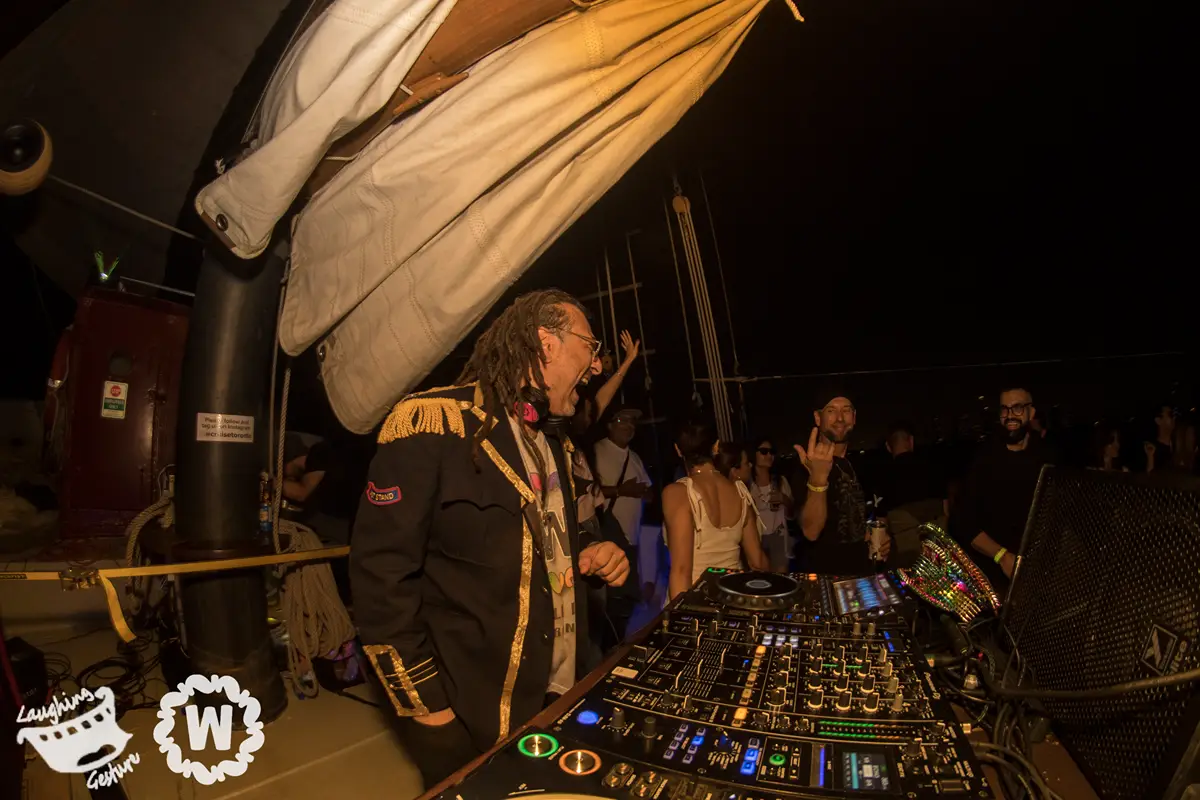 DJ plays music on a boat during the Annual Moonlight Cruise event.