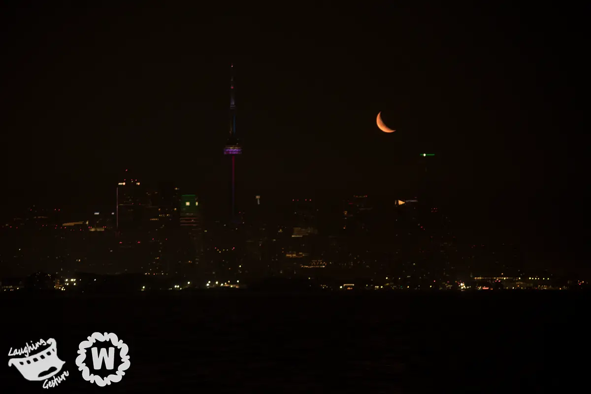 Red moon over cityscape