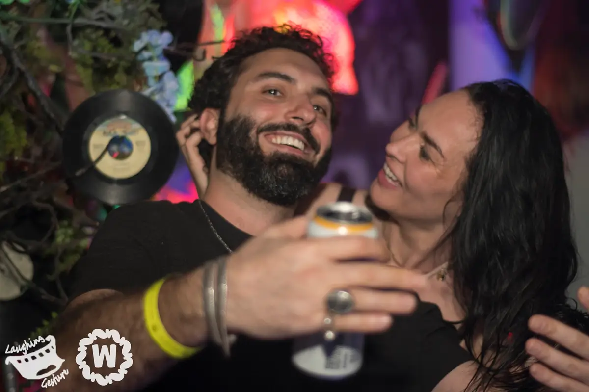 TAKiN ft Santouri couple smiling with drinks at a party