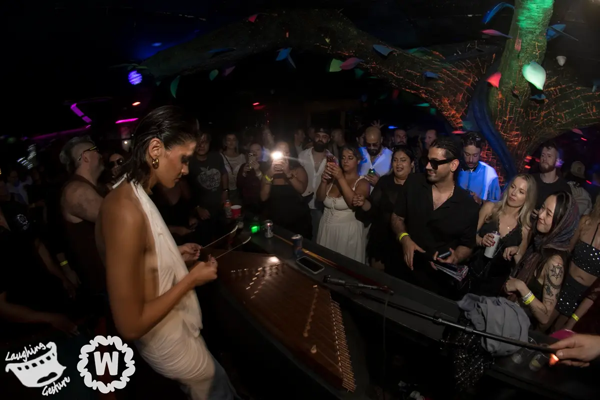 Woman playing santouri at TAKiN ft Santouri event with crowd watching